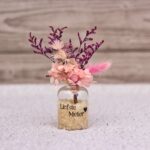 Vaasje met droogbloemen bedrukt voor de liefste meter.